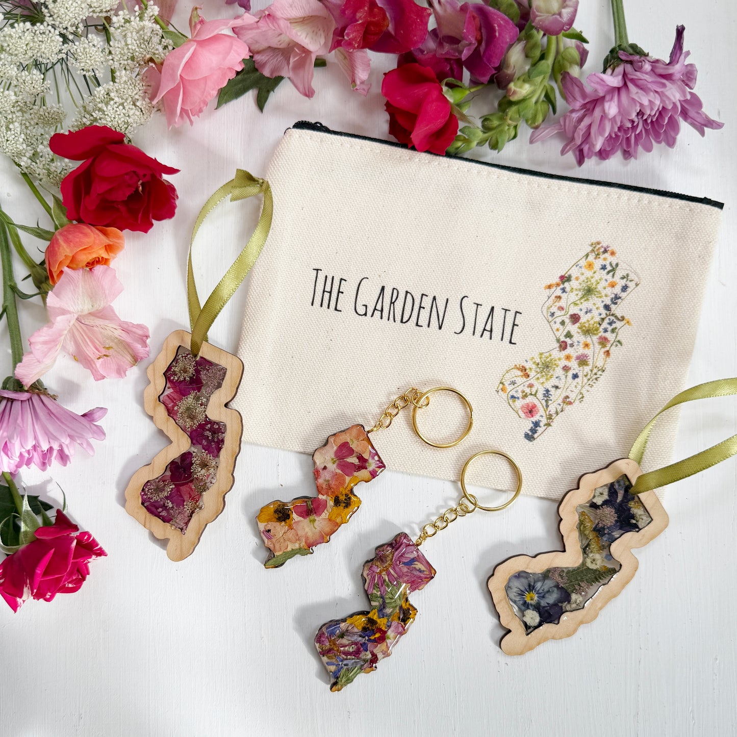 Christmas ornament in the shape of New Jersey filled with real flowers in resin