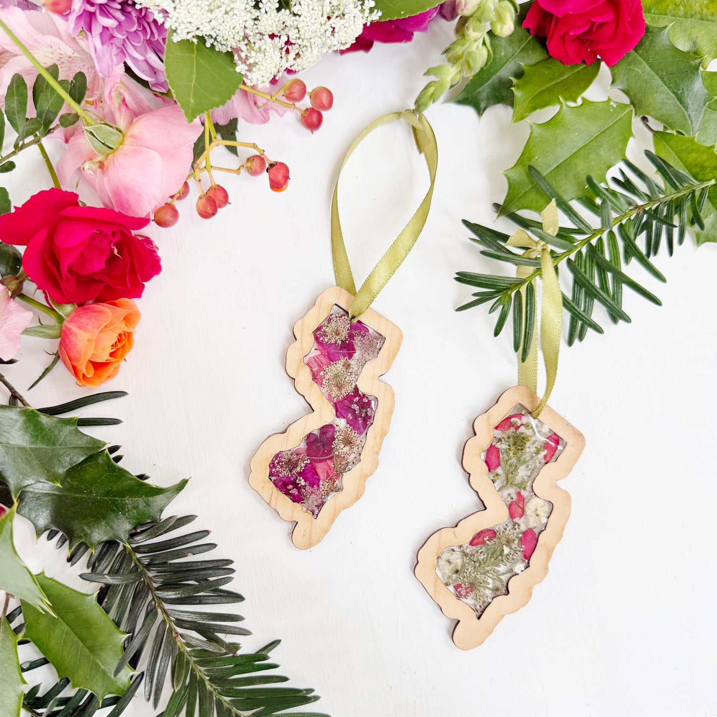 Christmas ornament in the shape of New Jersey filled with real flowers in resin